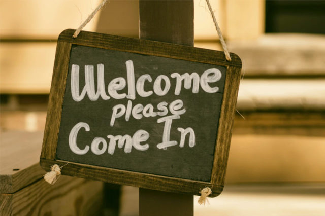 Welcome signing hanging on post