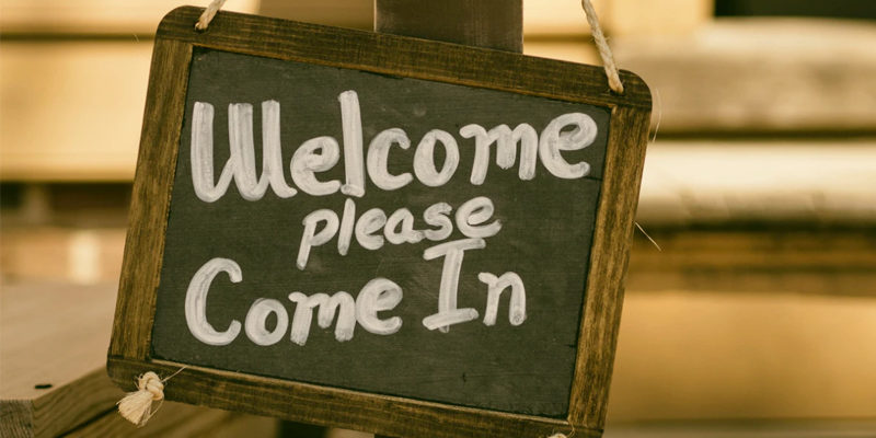 Welcome signing hanging on post